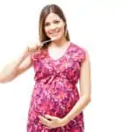 pregnant woman brushing teeth